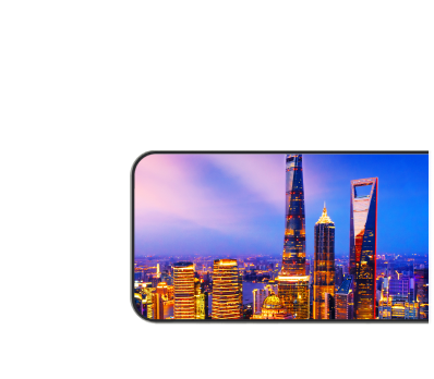 An image of a smartphone display with a clear night view of a city skyscraper.