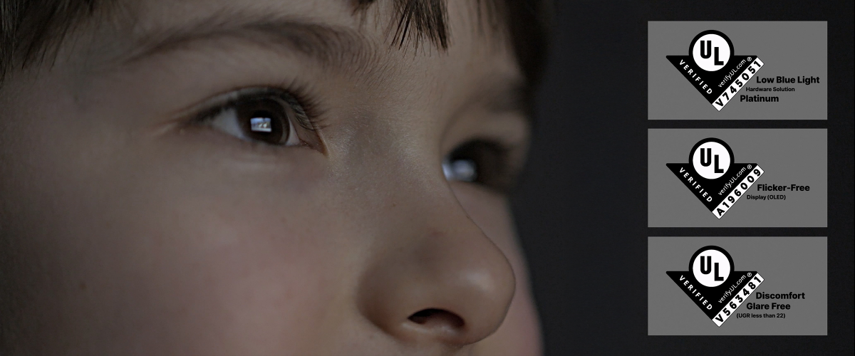 A close-up image of a child's face, emphasizing the eyes staring at the screen. To the right are three labels with the “UL Verified” logo, along with information about the low blue light, flicker-free, and glare reduction certifications.